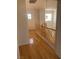 Upstairs hallway featuring hardwood floors, a wooden railing, and natural light at 10357 Bent Willow Ave, Las Vegas, NV 89129