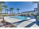 Resort-style pool with covered seating area surrounded by mature palm trees for a relaxing outdoor experience at 10357 Bent Willow Ave, Las Vegas, NV 89129
