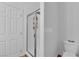 Bathroom with a glass door shower, toilet, and neutral wall, with a door to the left and hardwood-style floors at 10450 Gold Shadow Ave, Las Vegas, NV 89129