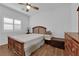 Comfortable bedroom with a ceiling fan, natural light, and a wooden bed frame at 10450 Gold Shadow Ave, Las Vegas, NV 89129