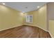 Bright, empty bedroom featuring light colored walls, and wood-look laminate flooring at 10450 Gold Shadow Ave, Las Vegas, NV 89129