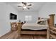 Bedroom with wood-look floors, fan, window with blinds, and a rustic wooden bed frame and matching furniture at 10450 Gold Shadow Ave, Las Vegas, NV 89129