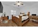 Bedroom with wood-look floors, fan, window with blinds, and a rustic wooden bed frame and matching furniture at 10450 Gold Shadow Ave, Las Vegas, NV 89129