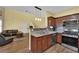 Open concept kitchen with stainless steel appliances and a view of the living room at 10450 Gold Shadow Ave, Las Vegas, NV 89129