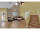 Inviting living room area featuring staircase, high ceiling, and great natural light at 10450 Gold Shadow Ave, Las Vegas, NV 89129