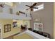 A cozy living room featuring high ceilings, a ceiling fan, and stylish decor at 10450 Gold Shadow Ave, Las Vegas, NV 89129