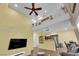 Bright living room features high ceilings, ceiling fan, and staircase to an elevated shelf at 10450 Gold Shadow Ave, Las Vegas, NV 89129
