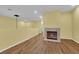 Cozy loft space with a fireplace, wood-look flooring, and ample natural light at 10450 Gold Shadow Ave, Las Vegas, NV 89129