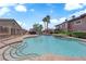 Inviting community pool with crystal-clear water, a waterfall feature, and lush landscaping at 10450 Gold Shadow Ave, Las Vegas, NV 89129