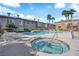 Community pool area featuring a hot tub, lounge chairs, and lush landscaping perfect for relaxation at 10450 Gold Shadow Ave, Las Vegas, NV 89129