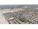 An aerial view displays a neighborhood with desert landscaping, paved roads, mountain views, and single-Gathering homes at 10650 Little Horse Creek Ave, Las Vegas, NV 89129