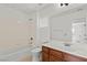 Bathroom with tile backsplash, white cabinets, and a bathtub at 10650 Little Horse Creek Ave, Las Vegas, NV 89129