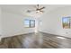 Spacious bedroom featuring wood-look floors, vaulted ceilings, and multiple windows showcasing mountain views at 10650 Little Horse Creek Ave, Las Vegas, NV 89129