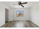 Bedroom with ceiling fan and a window looking out onto the architecture of neighboring houses at 10650 Little Horse Creek Ave, Las Vegas, NV 89129