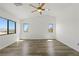 Bright bedroom showcasing wood-look floors, vaulted ceilings, and large windows for ample natural light at 10650 Little Horse Creek Ave, Las Vegas, NV 89129