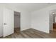 Bright bedroom featuring wood-look floors, a closet, and a neutral color palette at 10650 Little Horse Creek Ave, Las Vegas, NV 89129