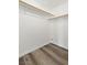 Walk-in closet features wood-look floors, white walls, and wooden racks at 10650 Little Horse Creek Ave, Las Vegas, NV 89129