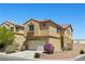Charming home with a two-car garage and beautiful landscaping on a sunny day at 10650 Little Horse Creek Ave, Las Vegas, NV 89129
