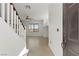 Bright foyer featuring neutral tile flooring, staircase and fresh white walls at 10650 Little Horse Creek Ave, Las Vegas, NV 89129
