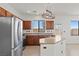 Bright kitchen featuring stainless steel appliances, island, and earth tone color palette at 10650 Little Horse Creek Ave, Las Vegas, NV 89129