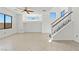 Spacious living room with neutral walls, tile floors, and staircase leading to upper floor at 10650 Little Horse Creek Ave, Las Vegas, NV 89129