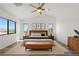Bedroom with a large bed, wood floors, neutral walls, and lots of natural light at 10650 Little Horse Creek Ave, Las Vegas, NV 89129