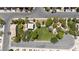 An aerial view showcases a neighborhood park with mature shade trees, green grass, walking paths, and a covered gazebo at 10650 Little Horse Creek Ave, Las Vegas, NV 89129