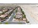 An elevated view showcasing a street with sidewalks and homes surrounded by desert landscaping and mountain views at 10650 Little Horse Creek Ave, Las Vegas, NV 89129
