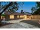 Charming backyard with covered patio, rock landscaping, and mature trees creating a private retreat at 10712 Aire Dr, Las Vegas, NV 89144