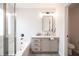 Stylishly appointed bathroom with modern vanity, large mirror, soaking tub, and walk-in shower at 10712 Aire Dr, Las Vegas, NV 89144