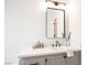 Bright bathroom featuring a gray vanity with white countertop, modern fixtures, and decorative accents at 10712 Aire Dr, Las Vegas, NV 89144