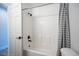 Clean, tiled shower and bathtub combination with a shower curtain and matte black fixtures at 10712 Aire Dr, Las Vegas, NV 89144