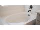 Close-up of a white tiled bathtub with matte black fixtures, providing a clean and modern aesthetic at 10712 Aire Dr, Las Vegas, NV 89144