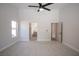 Carpeted bedroom with a ceiling fan and ensuite bathroom and closet providing a comfortable retreat at 10712 Aire Dr, Las Vegas, NV 89144