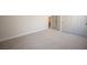 Bedroom with neutral carpet and baseboard trim, view of closet and ensuite at 10712 Aire Dr, Las Vegas, NV 89144