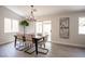 Dining room with modern table, six chairs, decorative lighting, and sliding glass door to outdoor space at 10712 Aire Dr, Las Vegas, NV 89144