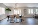 Dining room with modern table, six chairs, decorative lighting, and sliding glass door to outdoor space at 10712 Aire Dr, Las Vegas, NV 89144