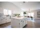 Open-concept kitchen with white cabinets, stainless steel appliances, quartz countertops, and view to dining area at 10712 Aire Dr, Las Vegas, NV 89144