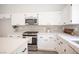 Bright kitchen featuring white cabinets, stainless steel appliances, and a stylish tile backsplash at 10712 Aire Dr, Las Vegas, NV 89144