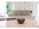 Bright kitchen featuring quartz countertops, modern backsplash, and sleek cabinetry at 10712 Aire Dr, Las Vegas, NV 89144