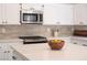 Well-appointed kitchen with stainless steel appliances, white cabinets, and light countertops at 10712 Aire Dr, Las Vegas, NV 89144
