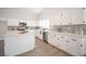 Bright kitchen with island, white cabinets, stainless steel appliances, quartz countertops, and stylish backsplash at 10712 Aire Dr, Las Vegas, NV 89144
