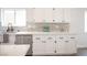 Kitchen area with white cabinets, quartz countertops, stainless steel appliances, and subway tile backsplash at 10712 Aire Dr, Las Vegas, NV 89144