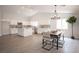 Bright modern kitchen with stainless steel appliances, white cabinets, and a dining area at 10712 Aire Dr, Las Vegas, NV 89144