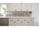 Kitchen featuring white cabinets, stainless appliances, and grey tile backsplash at 10712 Aire Dr, Las Vegas, NV 89144