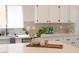 Bright kitchen features white cabinets and countertops, plus stylish backsplash at 10712 Aire Dr, Las Vegas, NV 89144