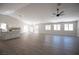 Large living room with light wood floors, recessed lights, ceiling fan, and modern chandelier at 10712 Aire Dr, Las Vegas, NV 89144