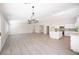 Large open-concept living room with a kitchen, island, and modern light fixture at 10712 Aire Dr, Las Vegas, NV 89144