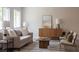 Cozy living room featuring neutral furniture, modern accents, and natural light at 10712 Aire Dr, Las Vegas, NV 89144