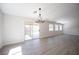 Bright living room with a sliding glass door leading to the backyard and several windows at 10712 Aire Dr, Las Vegas, NV 89144